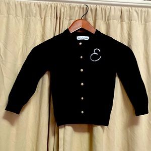 Girl’s black cardigan sweater with “E” initial. Size 5/6.